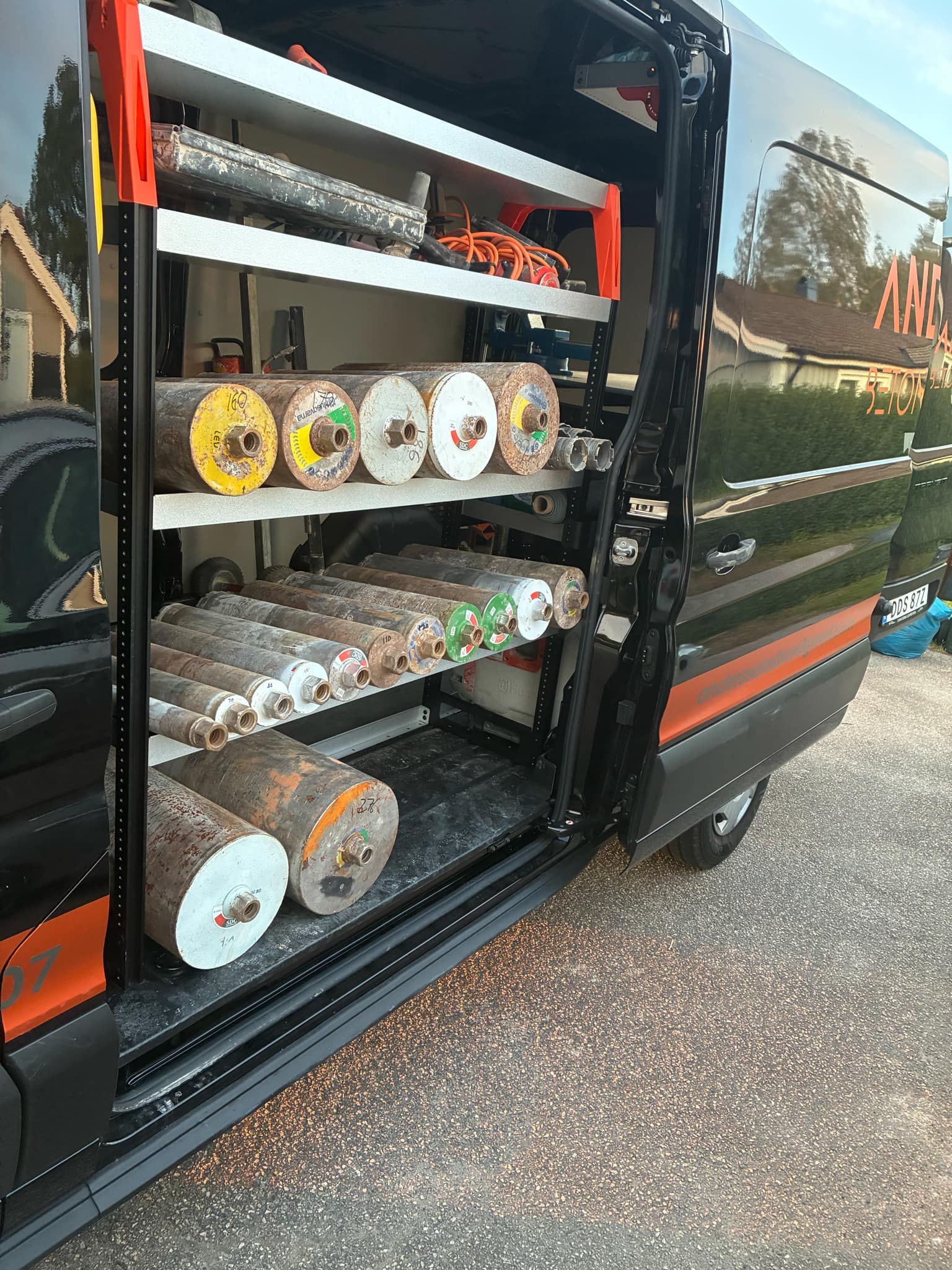 grayscale photography of man standing near open window